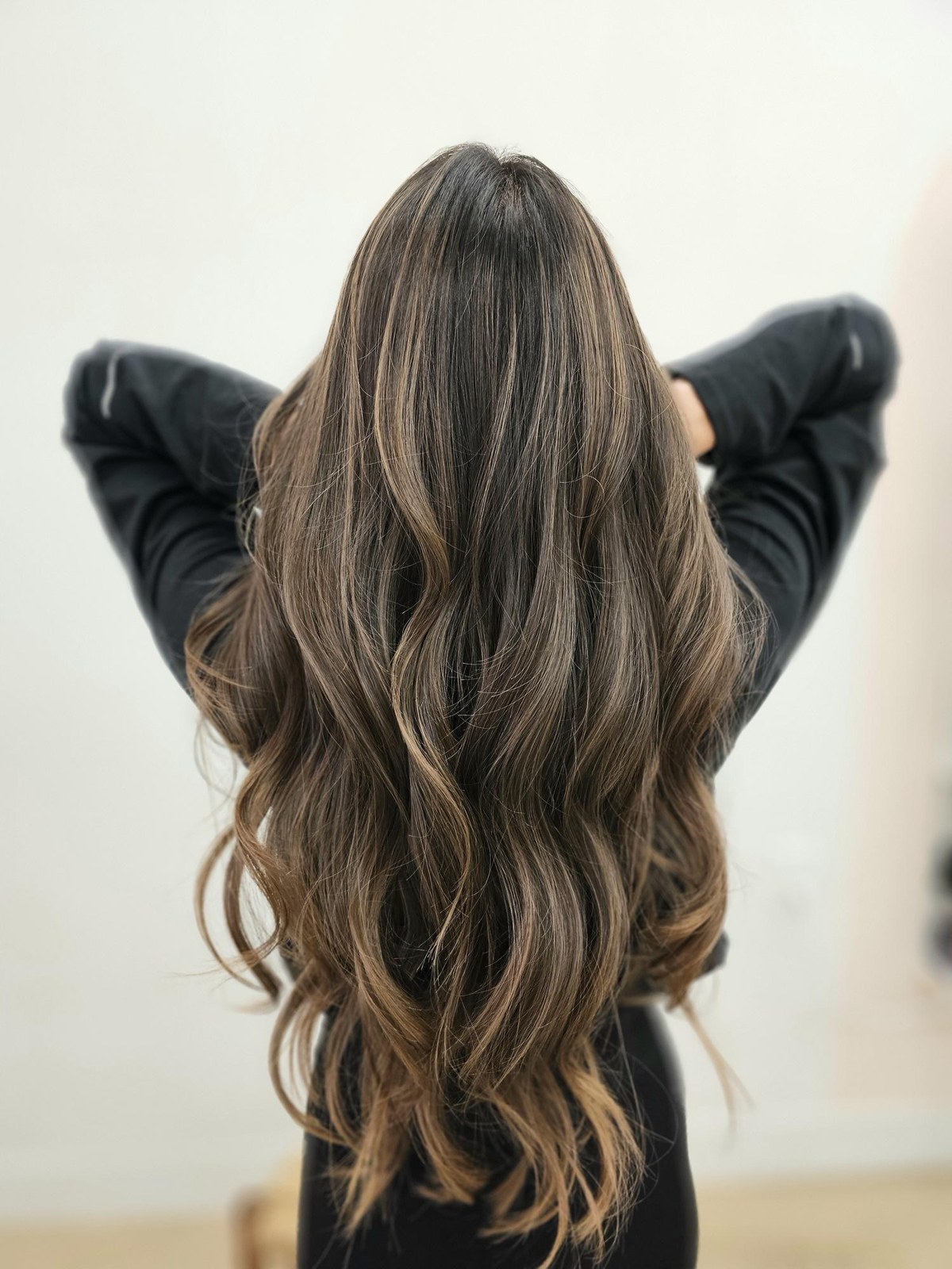 Long brunette waves with soft dimensional balayage by Mimi